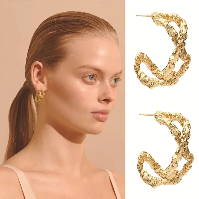 Model with chunky gold hoop earrings